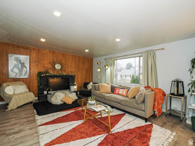 living area featuring recessed lighting, wooden walls, and wood finished floors
