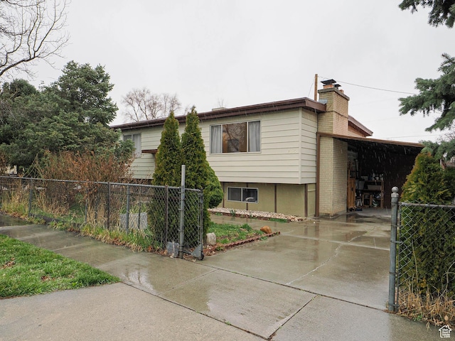 view of side of property with a chimney and fence