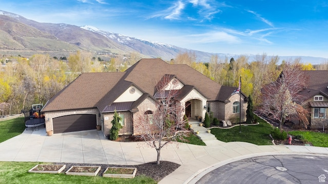 view of front facade featuring roof with shingles, concrete driveway, brick siding, a front yard, and a garage