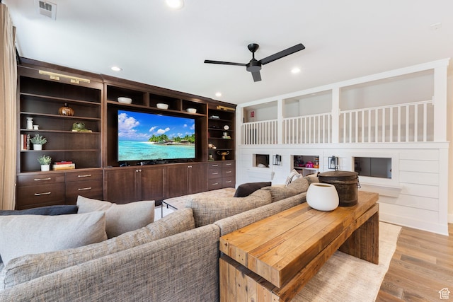 home theater with recessed lighting, light wood-style flooring, visible vents, and a ceiling fan