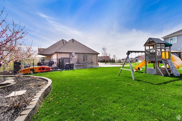view of yard featuring a playground and fence