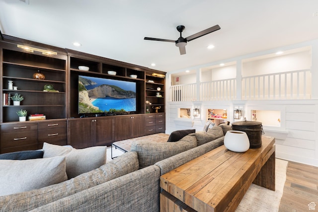 cinema room with ceiling fan, wood finished floors, and recessed lighting