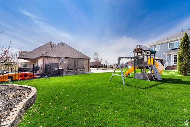 view of yard featuring fence and a playground