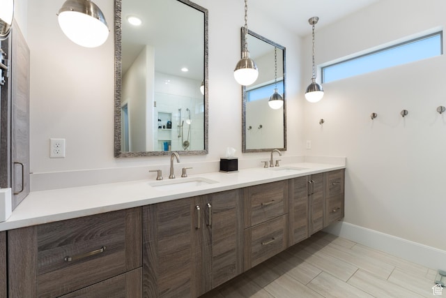 full bathroom with an enclosed shower, a sink, and double vanity