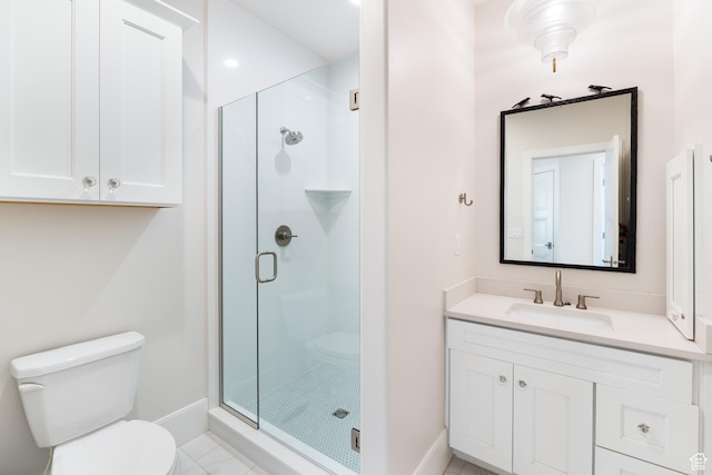 full bathroom featuring a shower stall, vanity, toilet, and baseboards