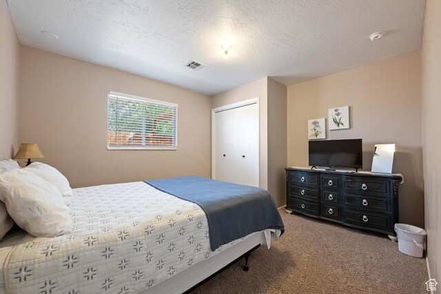 247 S 100 E, Hurricane, UT 84737 - carpeted bedroom with a textured ceiling, a closet, and visible vents
