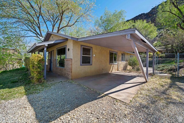 247 S 100 E, Hurricane, UT 84737 - exterior space with a gate, stucco siding, fence, and an attached carport