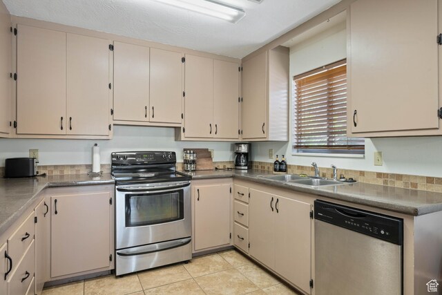 247 S 100 E, Hurricane, UT 84737 - kitchen featuring appliances with stainless steel finishes, light tile patterned floors, and a sink