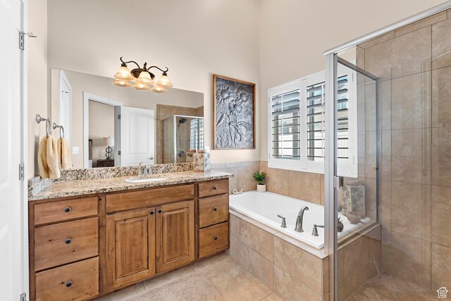 10756 S Autumn Wind Way W, South Jordan, UT 84009 - full bath featuring a garden tub, vanity, tile patterned flooring, a stall shower, and a notable chandelier