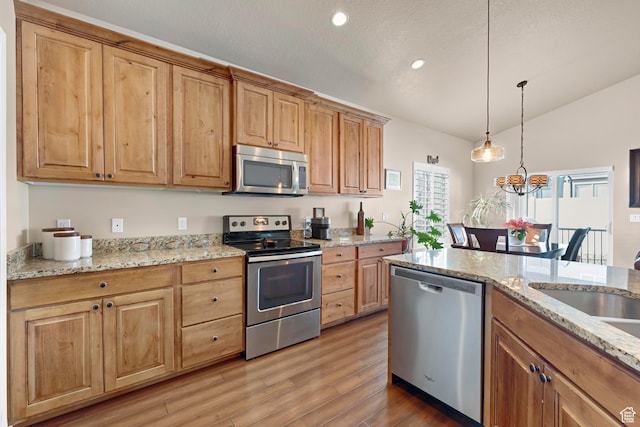 10756 S Autumn Wind Way W, South Jordan, UT 84009 - kitchen with hanging light fixtures, light wood-type flooring, recessed lighting, vaulted ceiling, and stainless steel appliances