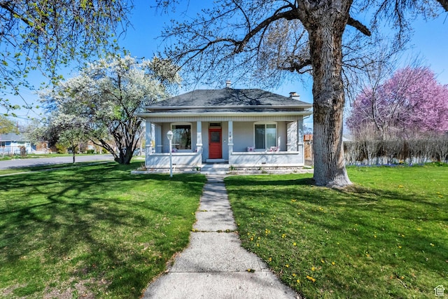 bungalow-style house with a porch and a front lawn
