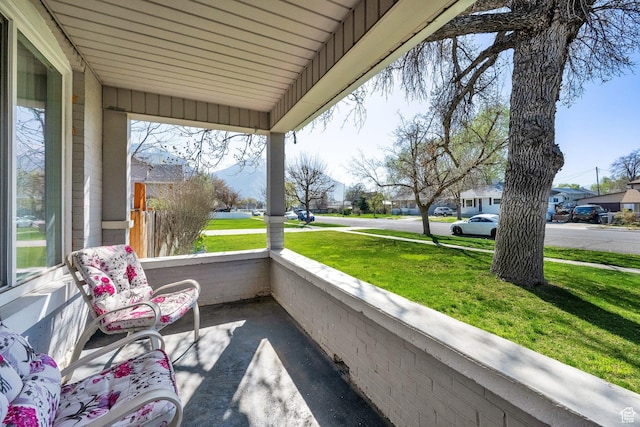 exterior space featuring covered porch and a residential view