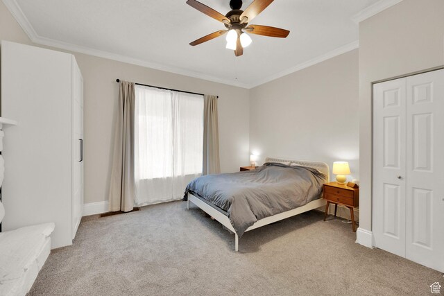 bedroom featuring ornamental molding, baseboards, a ceiling fan, and light colored carpet