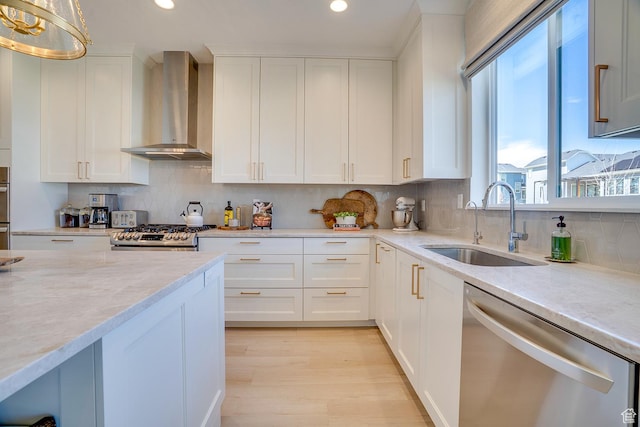 kitchen with a sink, dishwasher, wall chimney range hood, and recessed lighting