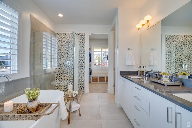 full bathroom with vanity, tile patterned flooring, recessed lighting, a freestanding bath, and a stall shower