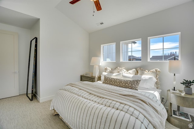bedroom featuring visible vents, baseboards, multiple windows, and light carpet