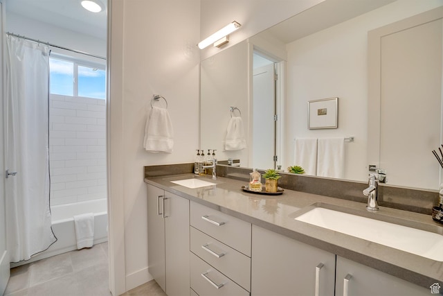 bathroom with a sink, tile patterned floors, double vanity, and shower / bath combination with curtain