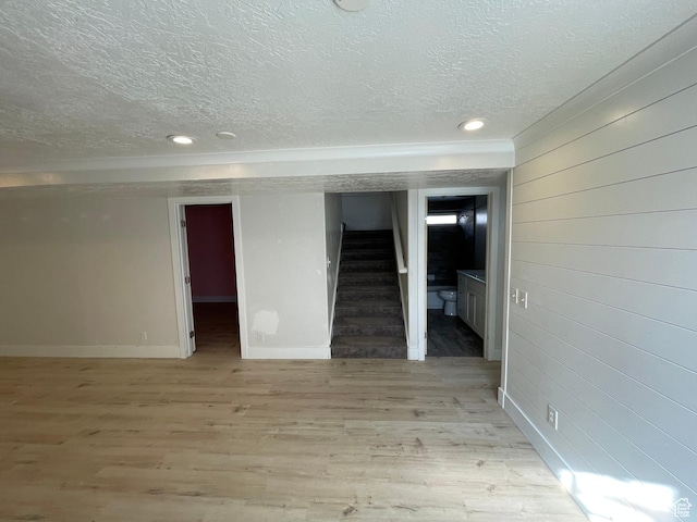 129 N 3rd E, Franklin, ID 83237 - finished basement featuring light wood-style flooring, stairway, recessed lighting, and a textured ceiling