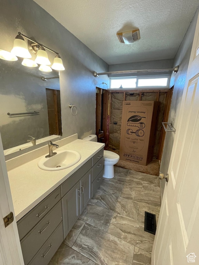 129 N 3rd E, Franklin, ID 83237 - bathroom with visible vents, walk in shower, toilet, a textured ceiling, and vanity