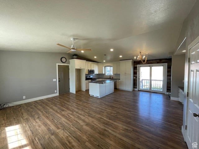 129 N 3rd E, Franklin, ID 83237 - kitchen featuring dark wood-type flooring, white cabinetry, a kitchen island, stainless steel microwave, and open floor plan