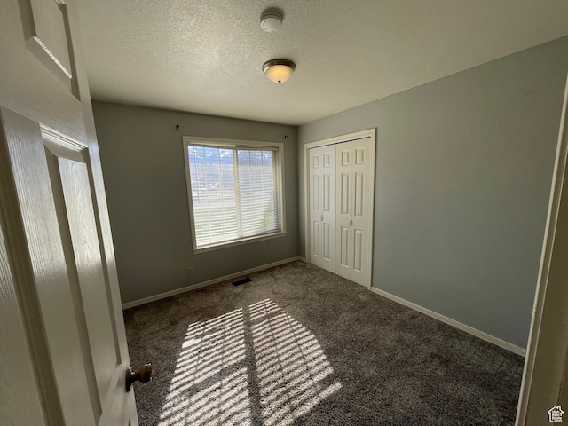 129 N 3rd E, Franklin, ID 83237 - unfurnished bedroom featuring baseboards, a closet, a textured ceiling, visible vents, and carpet
