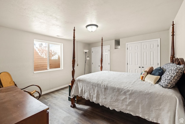 bedroom with wood finished floors, baseboards, and visible vents