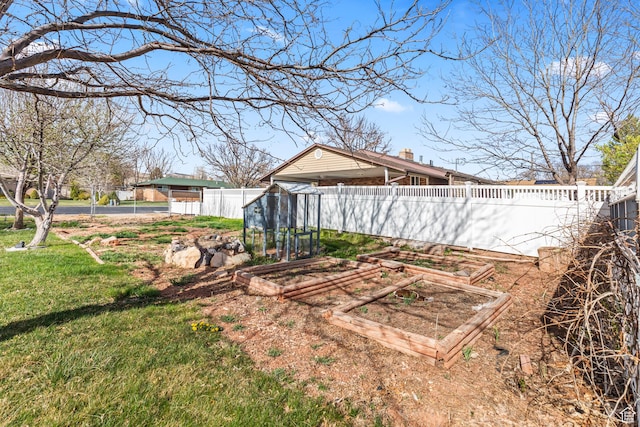 view of yard with a garden and fence