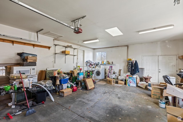 garage with a garage door opener and washer / dryer