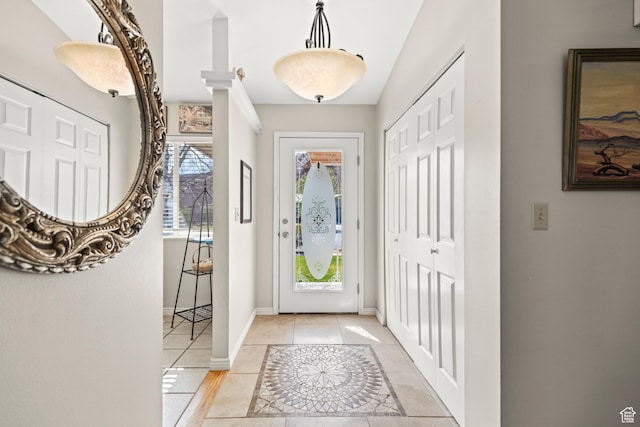 foyer with baseboards and light tile patterned flooring