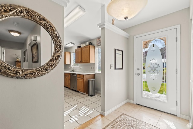 foyer entrance with light tile patterned flooring and baseboards