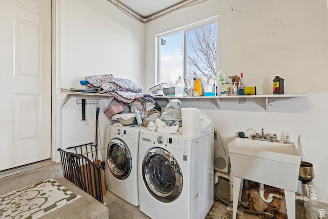 laundry room featuring independent washer and dryer, laundry area, and a sink