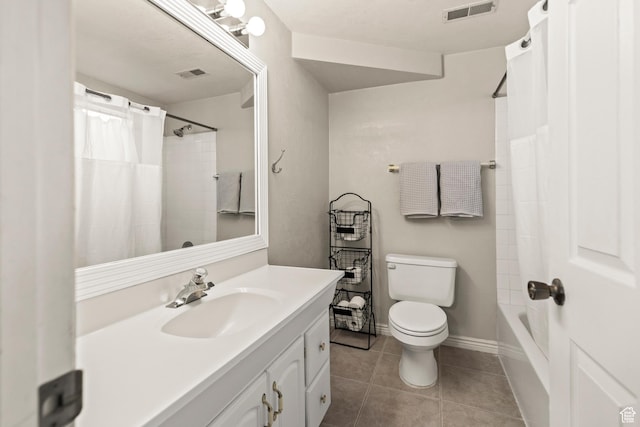 bathroom with toilet, vanity, tile patterned flooring, and visible vents