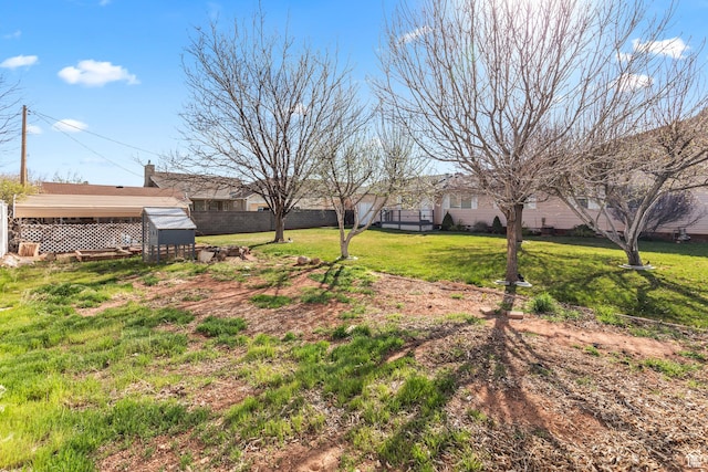 view of yard featuring an outdoor structure and fence