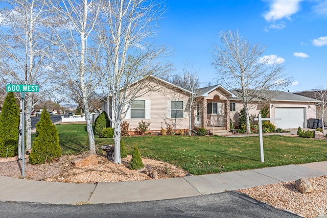 ranch-style house featuring a front lawn and a garage