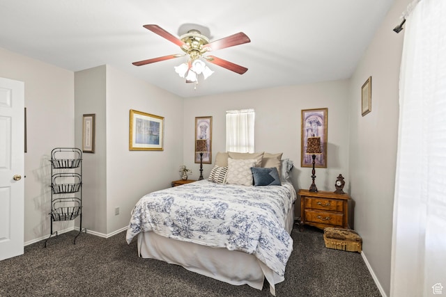 bedroom with dark carpet, ceiling fan, and baseboards