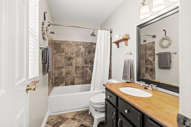 bathroom with shower / bathtub combination with curtain, vanity, stone finish floor, and toilet
