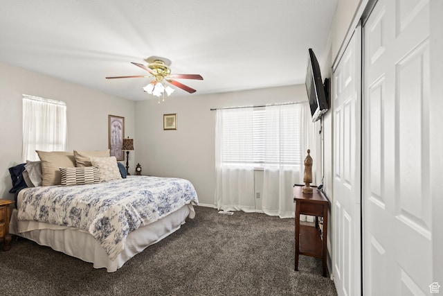 bedroom featuring dark carpet, ceiling fan, and baseboards