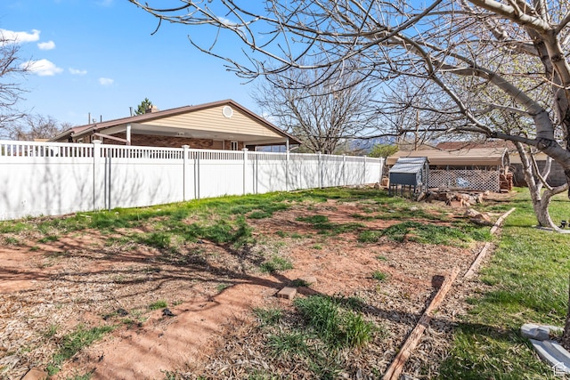 view of yard featuring fence private yard and an outdoor structure