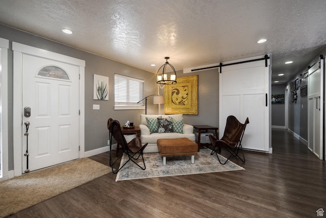 1674 E 1700 S, Naples, UT 84078 - foyer entrance with baseboards, recessed lighting, a textured ceiling, a barn door, and dark wood finished floors