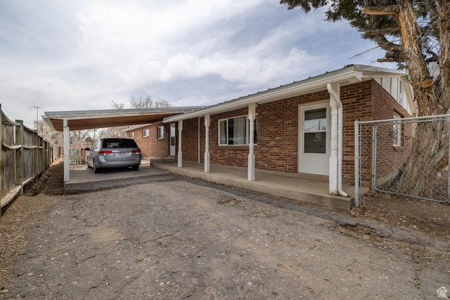 1674 E 1700 S, Naples, UT 84078 - exterior space with aphalt driveway, fence, an attached carport, and brick siding