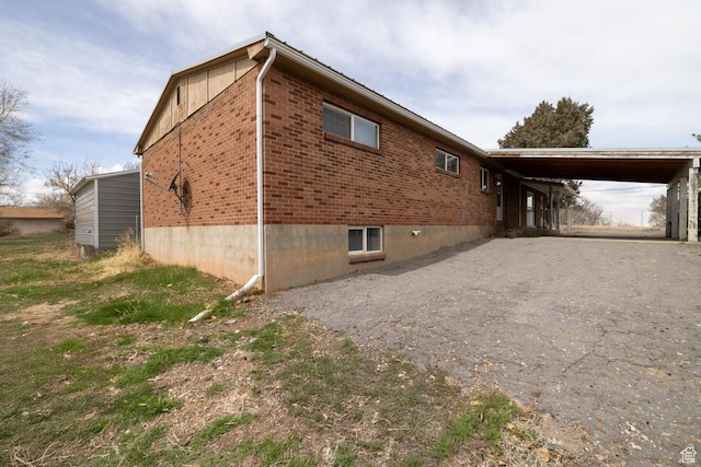 1674 E 1700 S, Naples, UT 84078 - view of side of property featuring gravel driveway, an attached carport, and brick siding