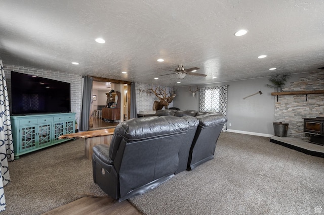 1674 E 1700 S, Naples, UT 84078 - living area with ceiling fan, a wood stove, a textured ceiling, recessed lighting, and baseboards