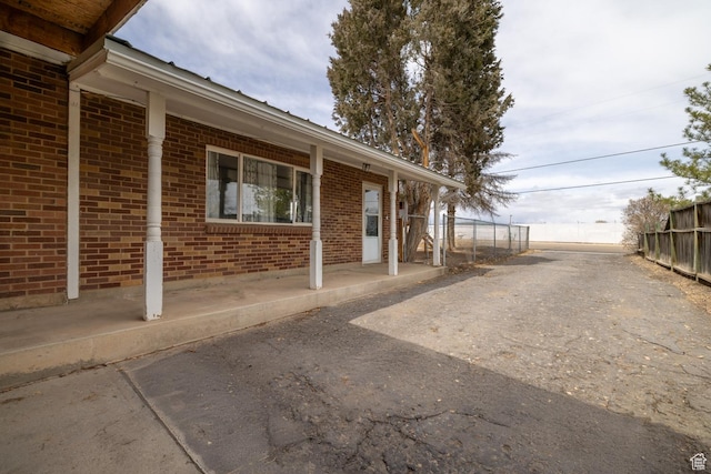 1674 E 1700 S, Naples, UT 84078 - view of property exterior featuring fence and brick siding
