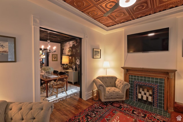 135 W 600 N, Salt Lake City, UT 84103 - living area with a tiled fireplace, an ornate ceiling, wood finished floors, and ceiling fan with notable chandelier