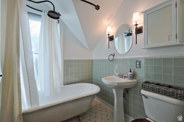 135 W 600 N, Salt Lake City, UT 84103 - bathroom featuring vaulted ceiling, toilet, wainscoting, a freestanding bath, and tile walls