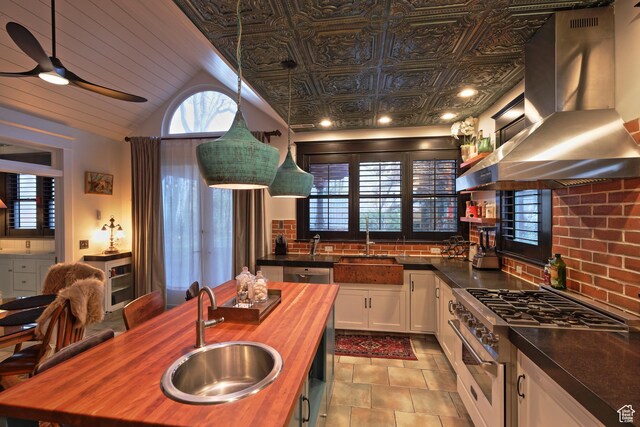 135 W 600 N, Salt Lake City, UT 84103 - kitchen featuring white cabinets, a sink, wooden counters, high end stainless steel range, and island range hood
