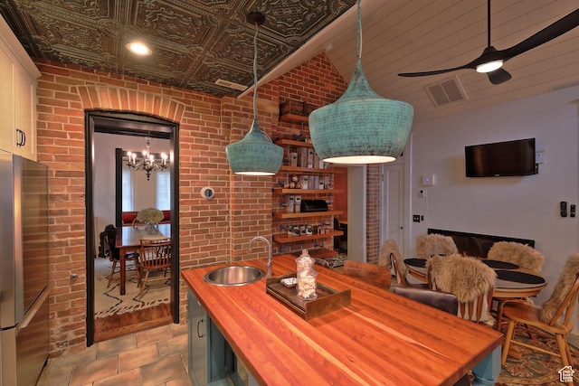 135 W 600 N, Salt Lake City, UT 84103 - dining space featuring brick wall, visible vents, and ceiling fan with notable chandelier