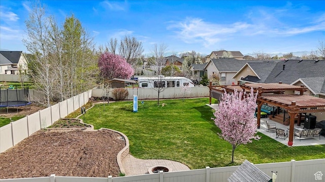 view of yard with a pergola, a trampoline, a fenced backyard, a patio, and a residential view