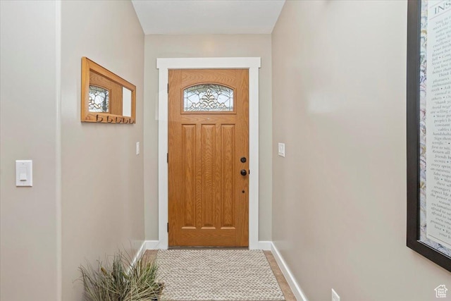 doorway to outside with baseboards