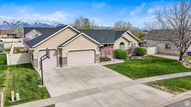 ranch-style home featuring concrete driveway, a gate, an attached garage, a front yard, and fence